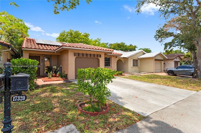 17320 NW 66th Pl, Hialeah, FL 33015 - mediterranean / spanish home featuring an attached garage, stucco siding, a tiled roof, concrete driveway, and solar panels