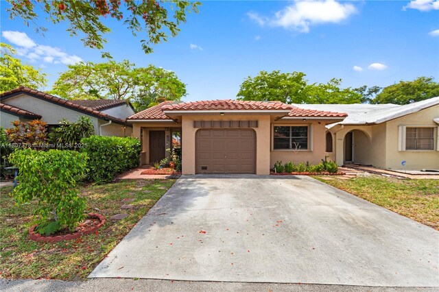17320 NW 66th Pl, Hialeah, FL 33015 - mediterranean / spanish-style house with an attached garage, stucco siding, a tiled roof, and concrete driveway