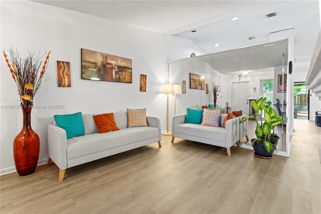 17320 NW 66th Pl, Hialeah, FL 33015 - living area with light wood-style flooring, lofted ceiling, baseboards, and recessed lighting