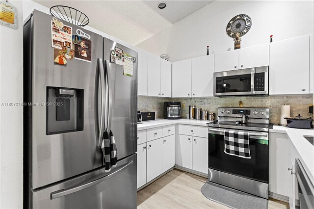 17320 NW 66th Pl, Hialeah, FL 33015 - kitchen with stainless steel appliances, light countertops, decorative backsplash, and white cabinetry