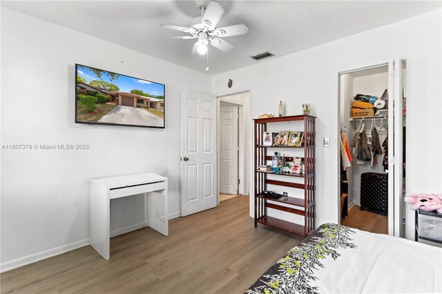 17320 NW 66th Pl, Hialeah, FL 33015 - bedroom featuring wood finished floors, baseboards, a spacious closet, a closet, and a ceiling fan