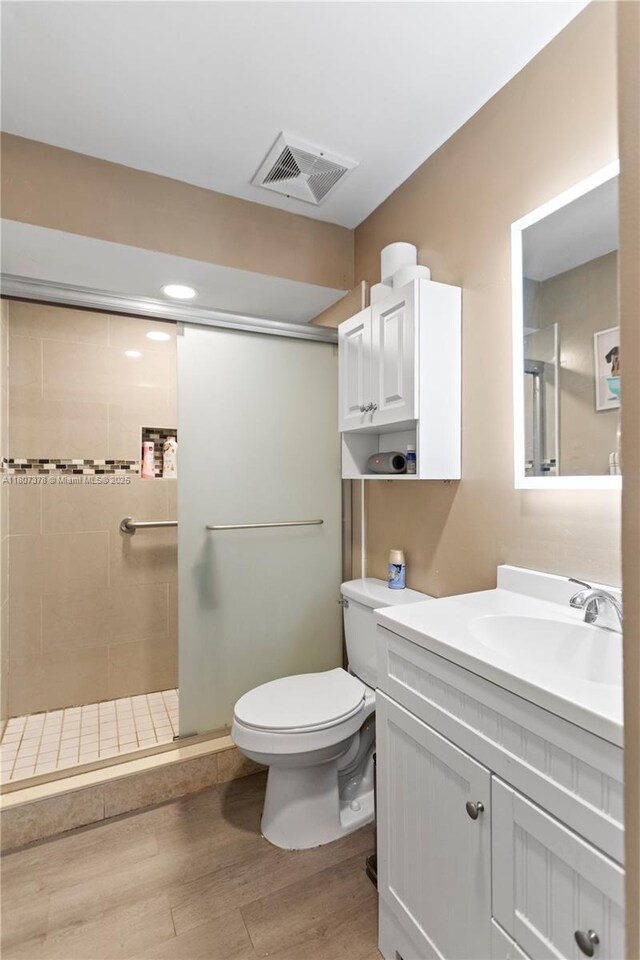 17320 NW 66th Pl, Hialeah, FL 33015 - bathroom featuring a stall shower, wood finished floors, toilet, and vanity