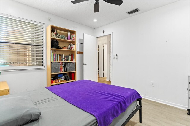 17320 NW 66th Pl, Hialeah, FL 33015 - bedroom featuring wood finished floors, a ceiling fan, baseboards, and a textured ceiling