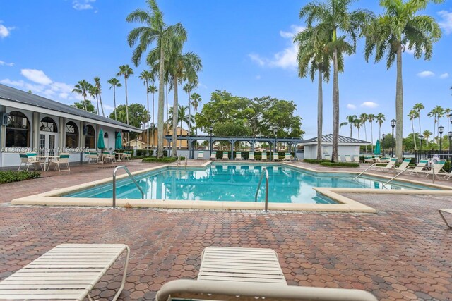 17320 NW 66th Pl, Hialeah, FL 33015 - community pool featuring french doors and a patio area