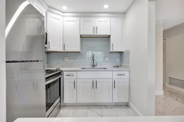 2929 SE Ocean Blvd Unit 123-2, Stuart, FL 34996 - kitchen featuring freestanding refrigerator, a sink, stainless steel electric range, light marble finish flooring, and baseboards