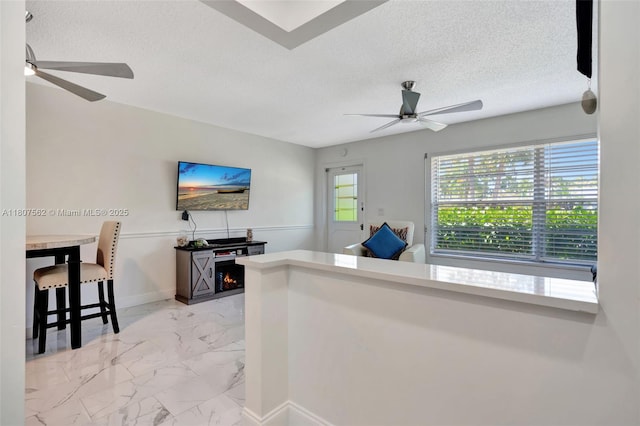 2929 SE Ocean Blvd Unit 123-2, Stuart, FL 34996 - office area with ceiling fan, light marble finish floors, a textured ceiling, and baseboards