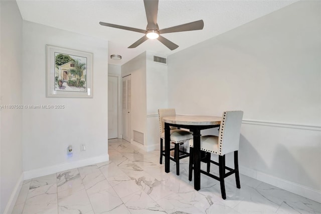 2929 SE Ocean Blvd Unit 123-2, Stuart, FL 34996 - dining area featuring baseboards, light marble finish flooring, and a ceiling fan