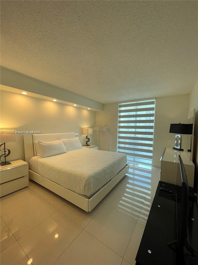 17555 Atlantic Blvd Unit 702, Sunny Isles Beach, FL 33160 - tiled bedroom featuring a textured ceiling