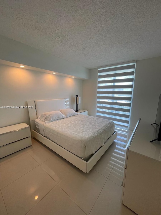 17555 Atlantic Blvd Unit 702, Sunny Isles Beach, FL 33160 - tiled bedroom with a textured ceiling