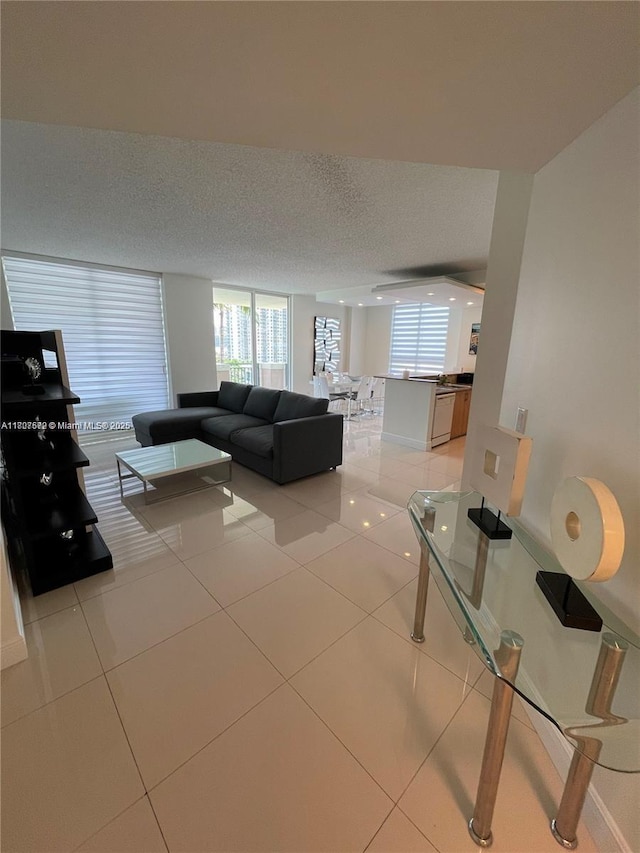 17555 Atlantic Blvd Unit 702, Sunny Isles Beach, FL 33160 - living area with light tile patterned floors, a textured ceiling, and baseboards