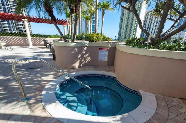 17555 Atlantic Blvd Unit 702, Sunny Isles Beach, FL 33160 - view of swimming pool featuring a hot tub, a pergola, a patio, and a view of city