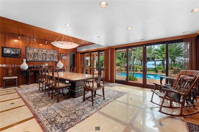 5725 N Bayshore Dr, Miami, FL 33137 - dining space with inlaid floor details, recessed lighting, wooden walls, and french doors
