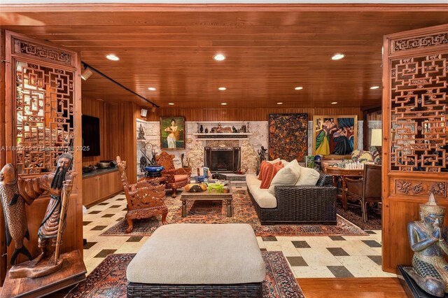 5725 N Bayshore Dr, Miami, FL 33137 - living area with tile patterned floors, wood ceiling, recessed lighting, and a stone fireplace