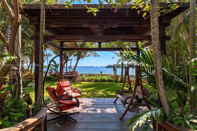 5725 N Bayshore Dr, Miami, FL 33137 - wooden terrace with a water view and a yard