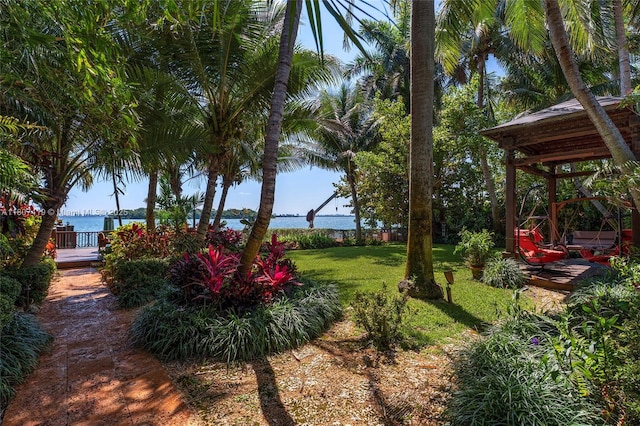 5725 N Bayshore Dr, Miami, FL 33137 - view of grassy yard with a deck with water view
