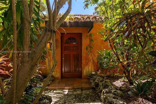 5725 N Bayshore Dr, Miami, FL 33137 - doorway to property featuring stucco siding