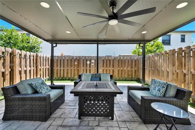 12982 SW 232nd Ln, Miami, FL 33170 - fenced backyard featuring an outdoor living space with a fire pit, a patio area, and a ceiling fan