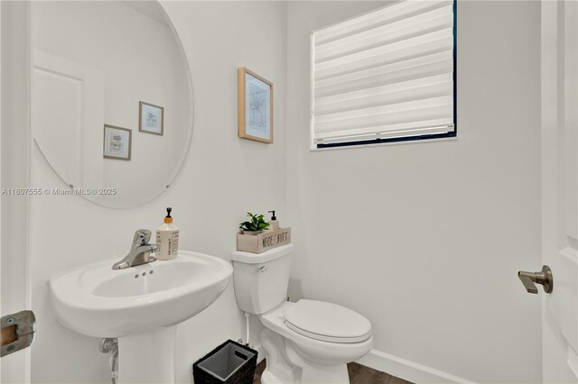 12982 SW 232nd Ln, Miami, FL 33170 - half bath featuring toilet, wood finished floors, baseboards, and a sink