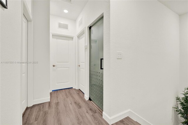 12982 SW 232nd Ln, Miami, FL 33170 - hallway featuring light wood-style flooring, baseboards, and recessed lighting