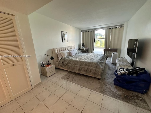 900 Bay Dr Unit 211, Miami Beach, FL 33141 - bedroom featuring light tile patterned floors