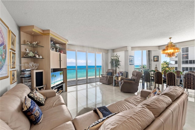 8925 Collins Ave Unit 4A, Surfside, FL 33154 - living room with a chandelier, light tile patterned floors, and a textured ceiling