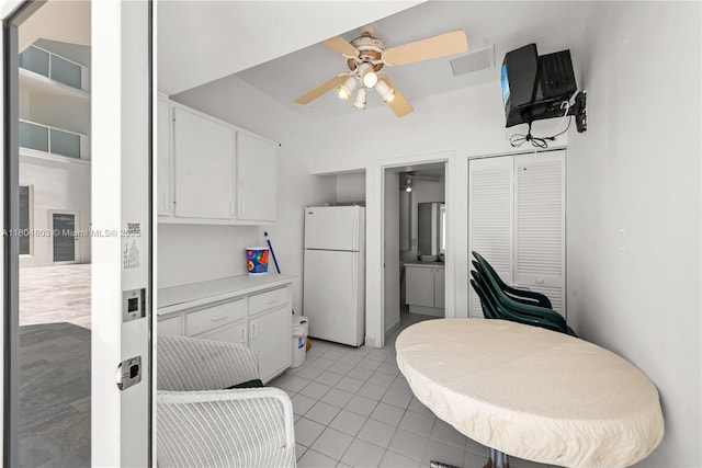 8925 Collins Ave Unit 4A, Surfside, FL 33154 - kitchen featuring freestanding refrigerator, a ceiling fan, light tile patterned floors, white cabinetry, and light countertops