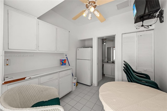 8925 Collins Ave Unit 4A, Surfside, FL 33154 - kitchen featuring freestanding refrigerator, light tile patterned floors, white cabinets, and light countertops