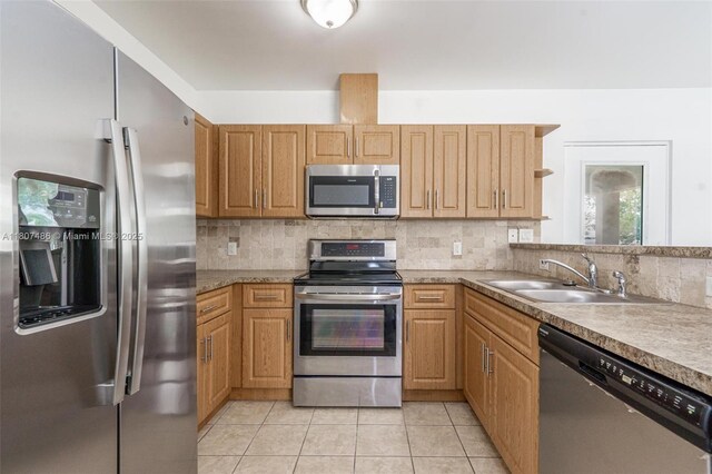 1402 E River Dr, Margate, FL 33063 - kitchen featuring appliances with stainless steel finishes, a sink, backsplash, and light tile patterned flooring