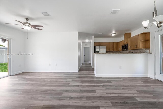 1402 E River Dr, Margate, FL 33063 - kitchen featuring stainless steel appliances, open shelves, and wood finished floors