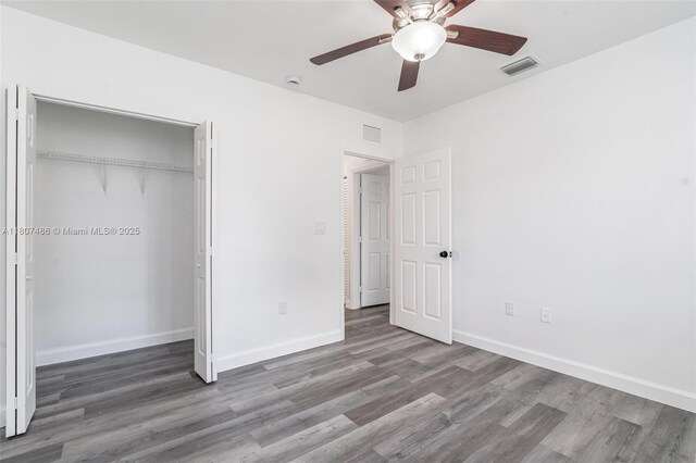 1402 E River Dr, Margate, FL 33063 - unfurnished bedroom featuring wood finished floors, baseboards, a closet, and ceiling fan