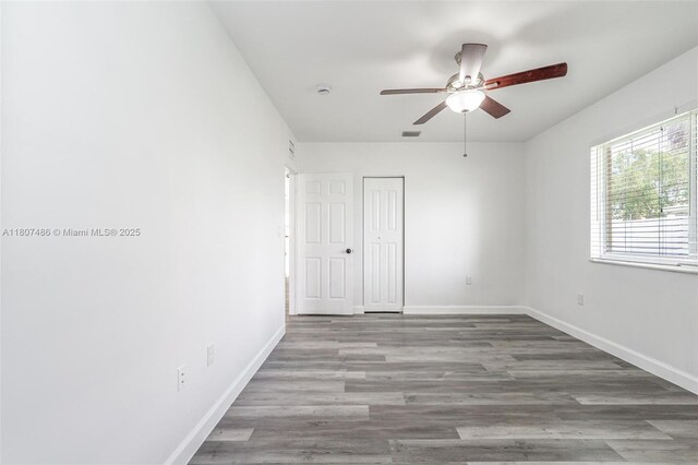 1402 E River Dr, Margate, FL 33063 - unfurnished room featuring ceiling fan, baseboards, wood finished floors, and a smoke detector