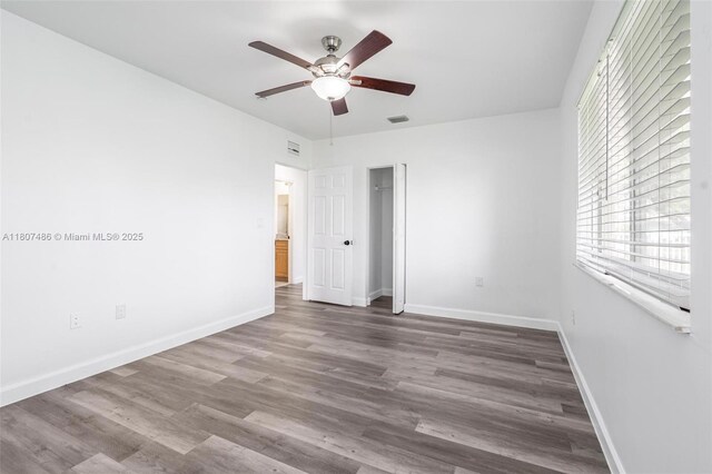 1402 E River Dr, Margate, FL 33063 - unfurnished bedroom with wood finished floors, baseboards, and a ceiling fan