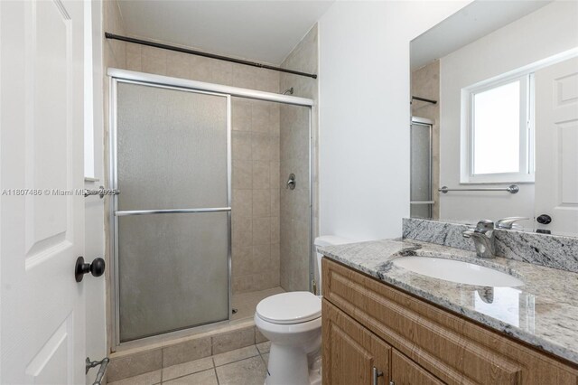 1402 E River Dr, Margate, FL 33063 - bathroom featuring tile patterned flooring, a shower stall, vanity, and toilet