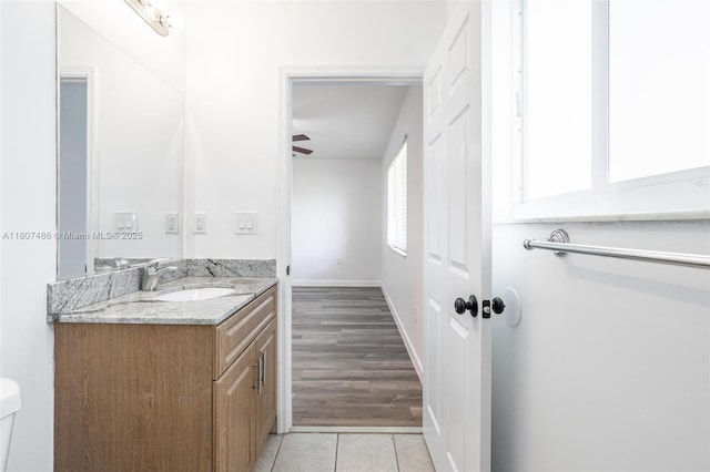1402 E River Dr, Margate, FL 33063 - bathroom with vanity, tile patterned flooring, toilet, baseboards, and a ceiling fan