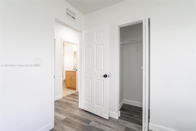 1402 E River Dr, Margate, FL 33063 - unfurnished bedroom with wood finished floors, baseboards, and a closet