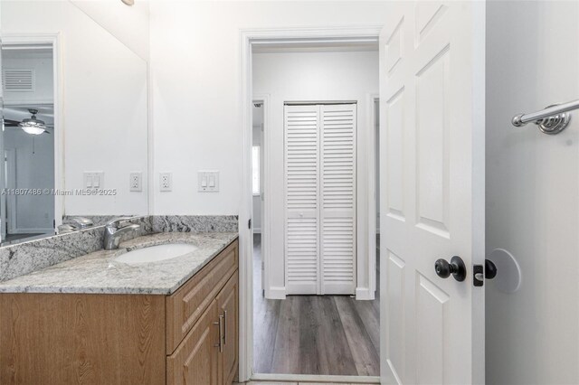 1402 E River Dr, Margate, FL 33063 - bathroom with vanity, wood finished floors, and a ceiling fan