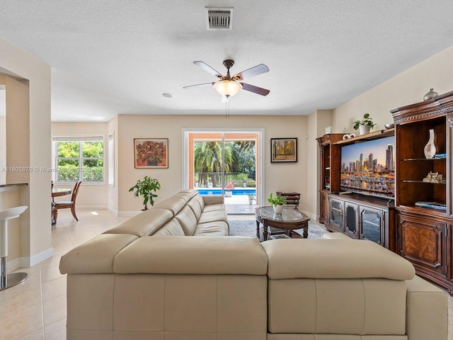 19165 N Gardenia Ave, Weston, FL 33332 - living room with ceiling fan, light tile patterned floors, baseboards, and a textured ceiling