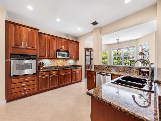 19165 N Gardenia Ave, Weston, FL 33332 - kitchen with stainless steel appliances, a sink, backsplash, recessed lighting, and dark stone countertops