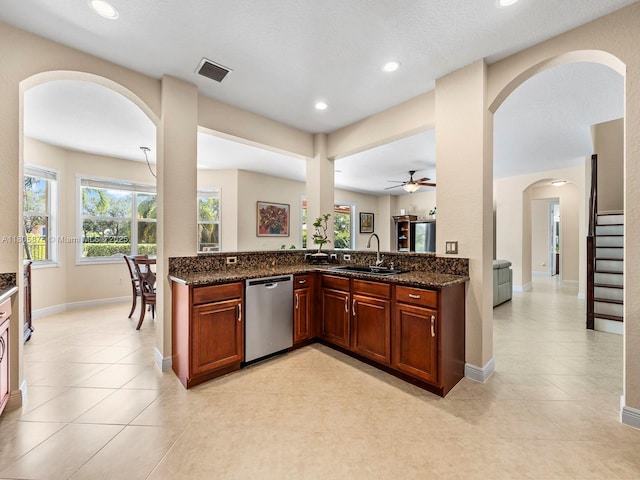 19165 N Gardenia Ave, Weston, FL 33332 - kitchen featuring dishwasher, a sink, arched walkways, ceiling fan, and dark stone countertops