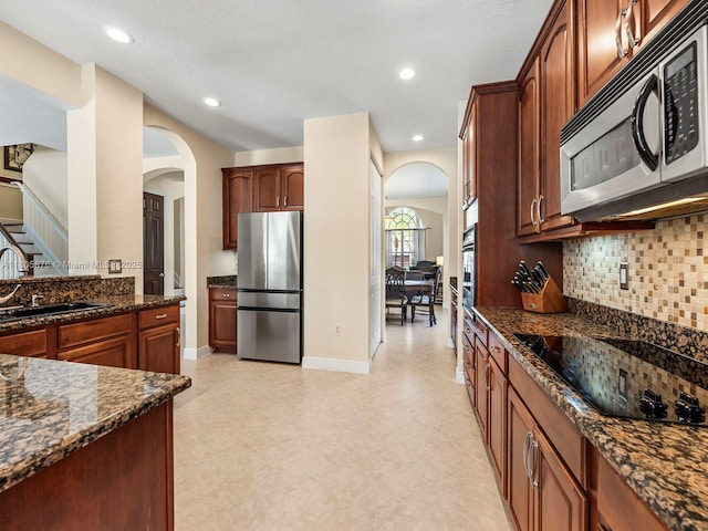 19165 N Gardenia Ave, Weston, FL 33332 - kitchen with stainless steel appliances, arched walkways, a sink, decorative backsplash, and recessed lighting