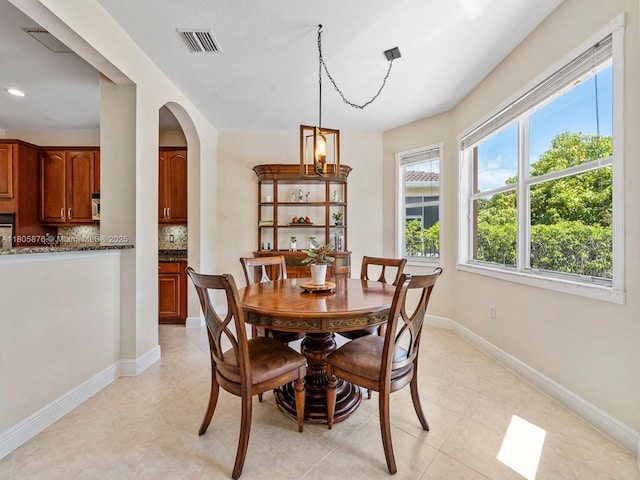 19165 N Gardenia Ave, Weston, FL 33332 - dining room featuring arched walkways, baseboards, and recessed lighting