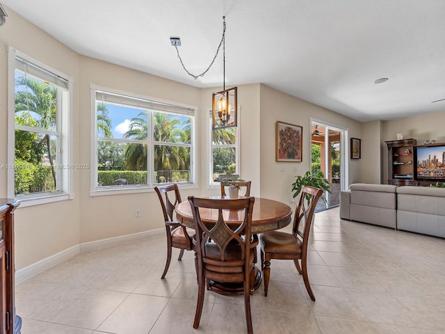 19165 N Gardenia Ave, Weston, FL 33332 - dining area featuring healthy amount of natural light, light tile patterned floors, baseboards, and a chandelier