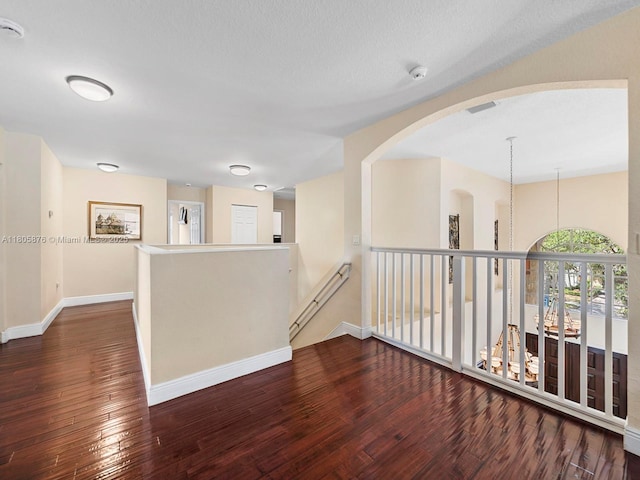 19165 N Gardenia Ave, Weston, FL 33332 - empty room featuring hardwood / wood-style floors, baseboards, a smoke detector, and arched walkways