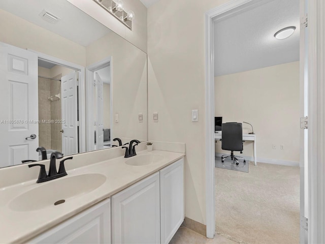 19165 N Gardenia Ave, Weston, FL 33332 - bathroom with tiled shower, double vanity, and baseboards