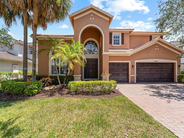 19165 N Gardenia Ave, Weston, FL 33332 - mediterranean / spanish home with stucco siding, a tiled roof, decorative driveway, a front yard, and french doors