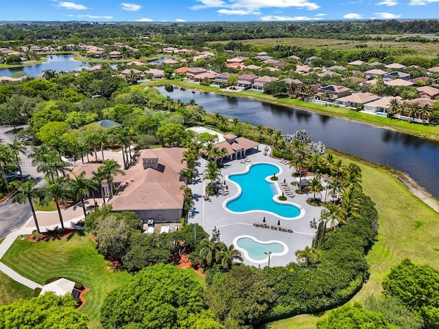 19165 N Gardenia Ave, Weston, FL 33332 - aerial view of property and surrounding area featuring a pool, a nearby body of water, nearby suburban area, and a tree filled landscape