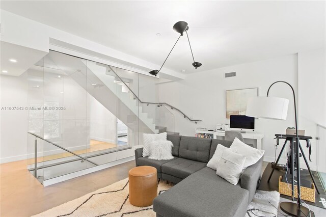 455 NE 39th St Unit 102, Miami, FL 33137 - living room featuring stairway and concrete flooring