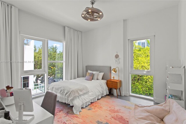 455 NE 39th St Unit 102, Miami, FL 33137 - bedroom with multiple windows and a chandelier