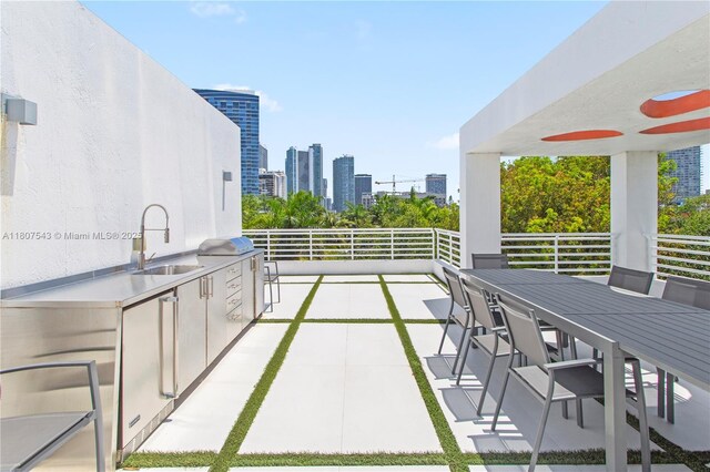 455 NE 39th St Unit 102, Miami, FL 33137 - view of patio with a sink, outdoor dining area, exterior kitchen, and a view of skyline