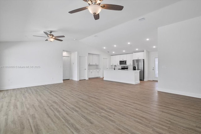 520 SW 28th St, Cape Coral, FL 33914 - unfurnished living room with a ceiling fan, light wood-style flooring, lofted ceiling, and recessed lighting
